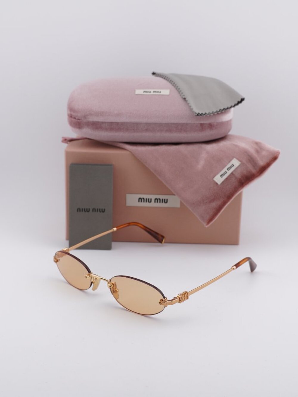 Miu Miu MU A54S 7OE90X Oval Rimless Sunglasses – Brass / Orange